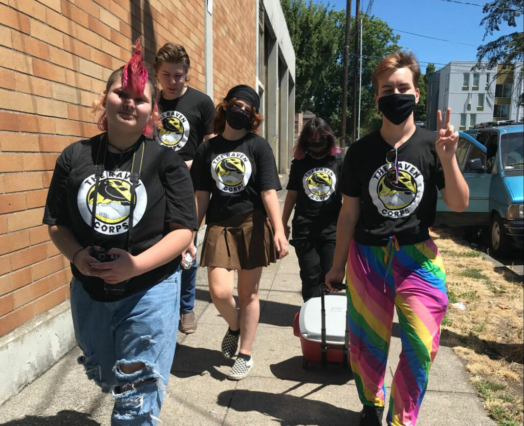 Group of 5 Ravens walking to an event wearing their Raven Corps t shirts
